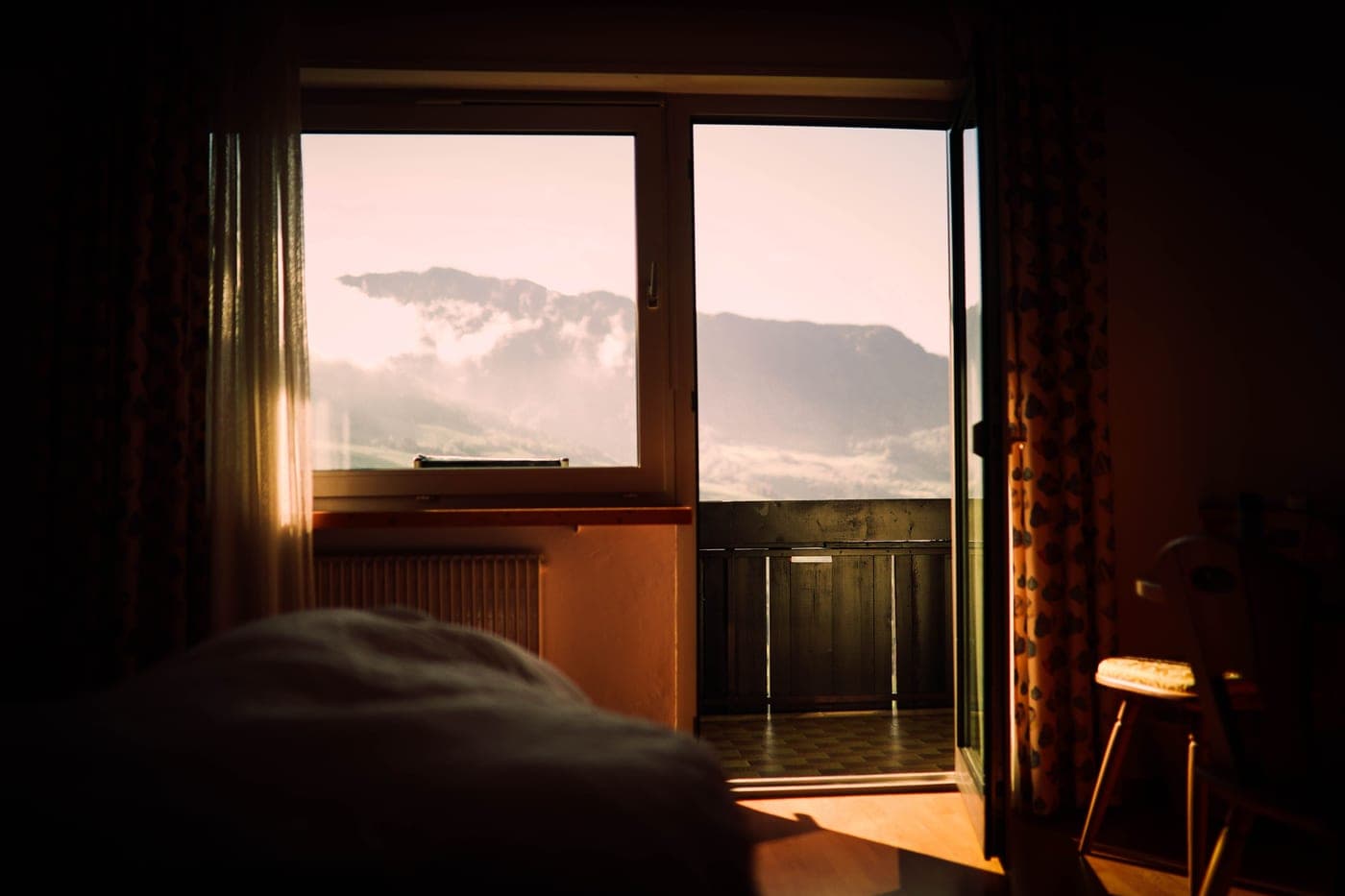 Early dawn light coming through a bedroom curtain